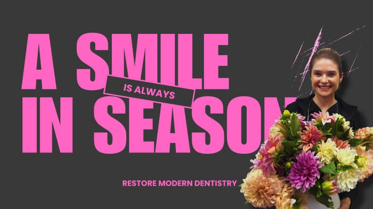 Dental team member at Restore Modern Dentistry in Bentonville, Arkansas, smiling while holding a fresh bouquet of flowers, symbolizing the beauty and confidence of a healthy smile.